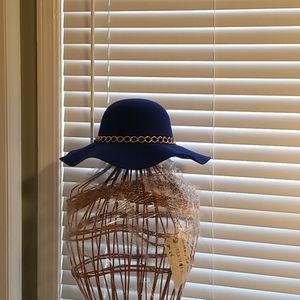 Blue. Floppy hat with gold chain.